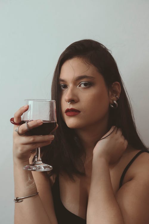 A Woman in Black Tank Top Holding a Wine Glass