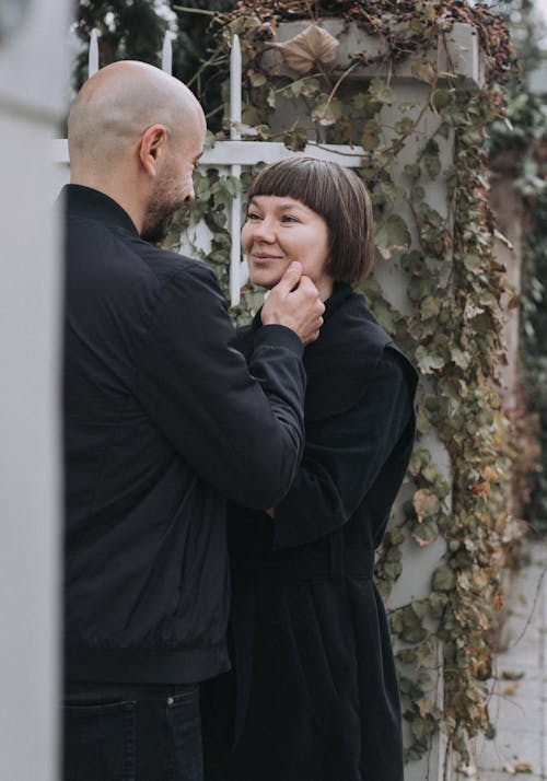 A Man Touching a Woman's Face while Looking at Each Other