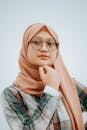 Portrait of a Young Woman Wearing Eyeglasses and a Headscarf