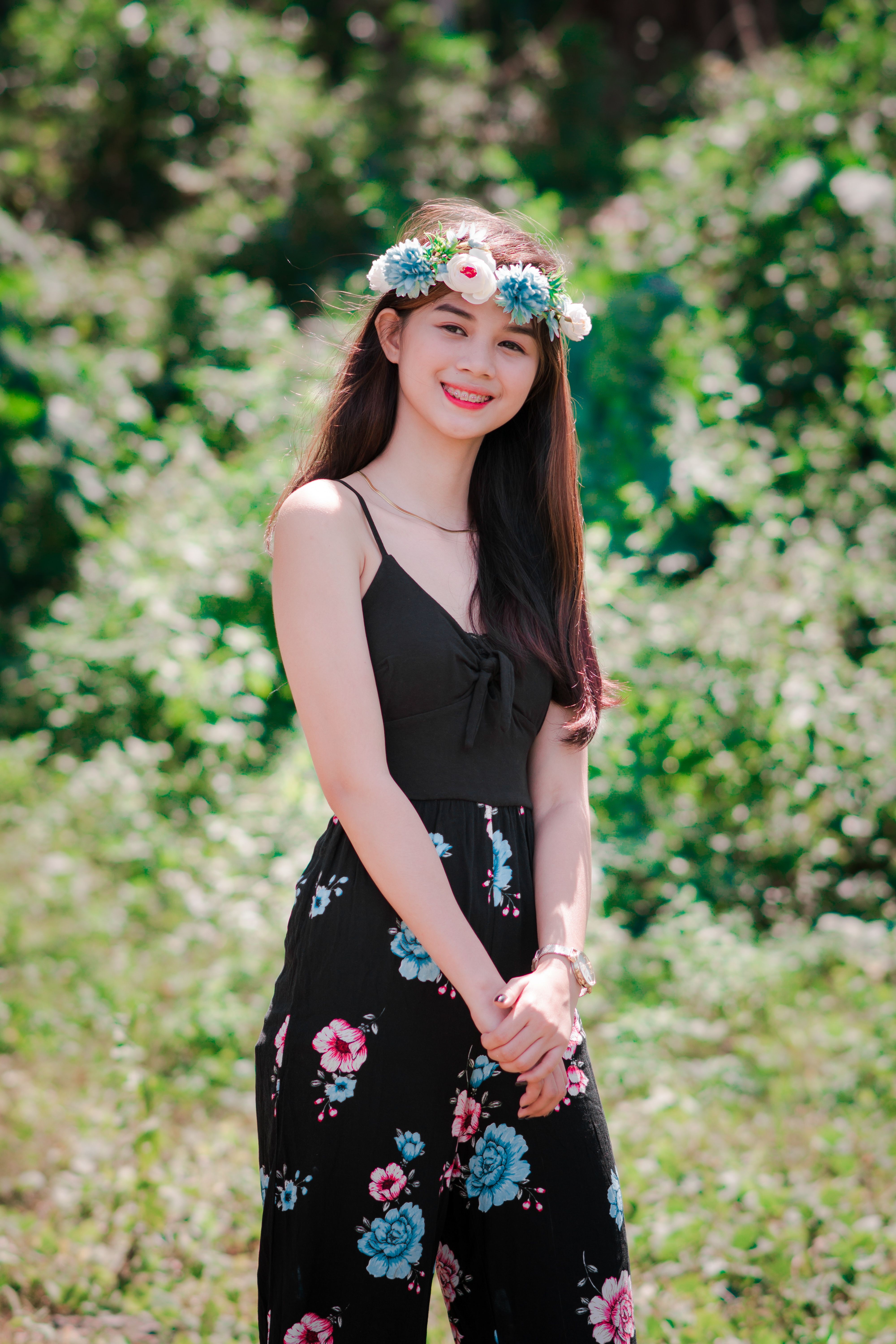 A Woman in Floral Skirt Smiling while Wearing Flower Crown · Free Stock ...