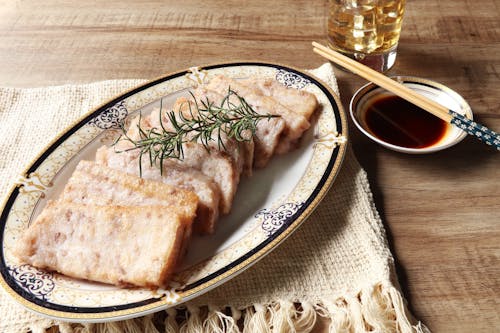 Photo of Slices of Fried Meat Near Soy Sauce and Chopsticks