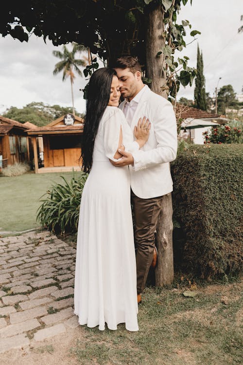 Loving newlyweds in elegant clothes in garden