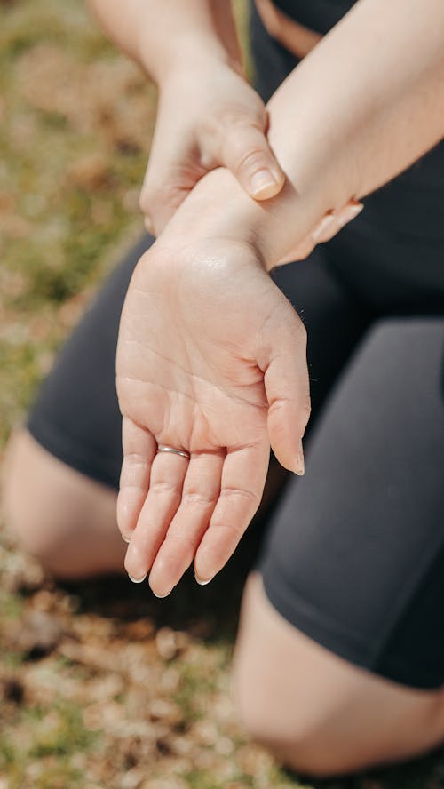 Photo of a Person Touching Her Arm