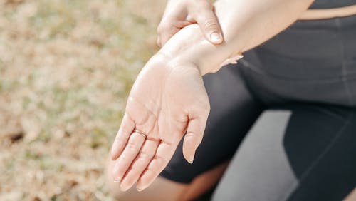 Free Close-Up Photo of a Woman Stretching Her Wrist Stock Photo