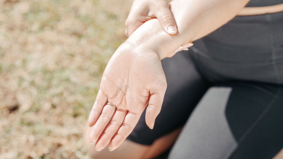 Woman holding painful wrist representing wrist ultrasound assessment