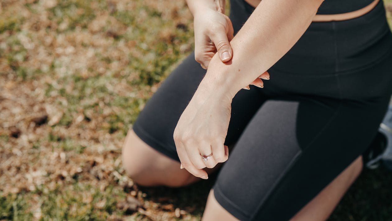 Woman in Black Shorts With Red Manicure