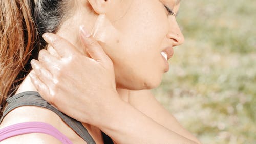 Close-Up Photo of Woman Having a Neck Pain