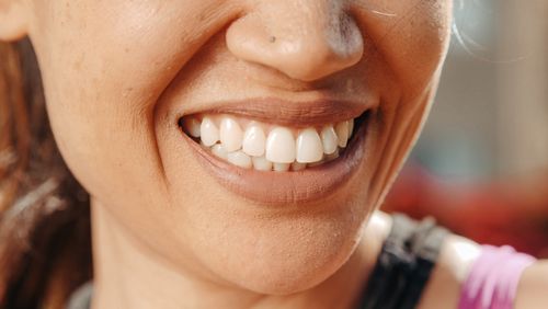 Free A close-up of a woman's smile, showcasing healthy teeth and natural skin tone. Stock Photo