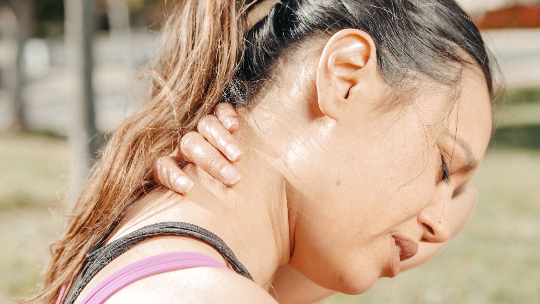 Woman experiencing neck discomfort after an injury