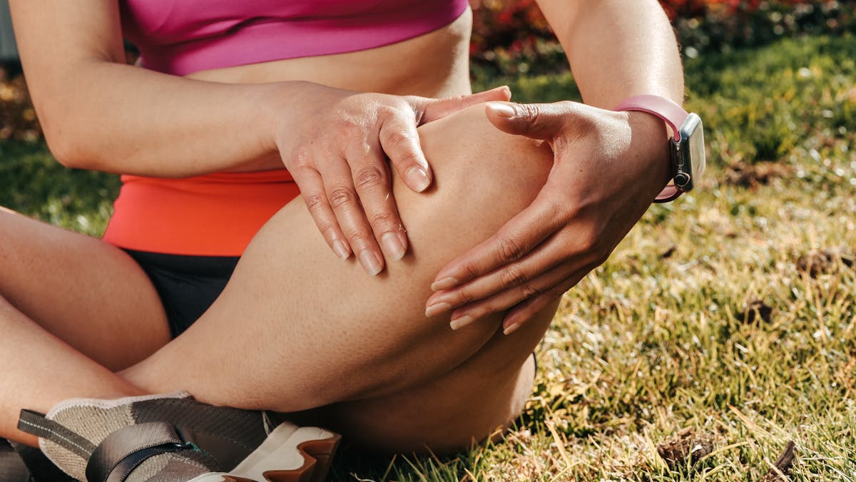 Close-up of Woman Sitting While Holding Knees