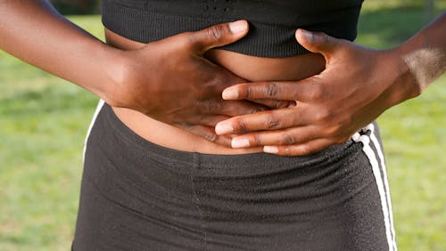 Free Close Up Photo of Person having Stomach Pain Stock Photo