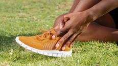 A Person Touching His Ankle