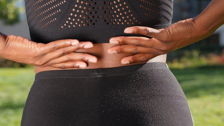 Close-Up Photo Of A Person Having A Back Pain