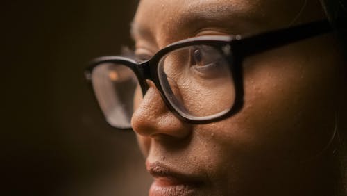 Close-Up Photo of a Serious Person Wearing Eyeglasses