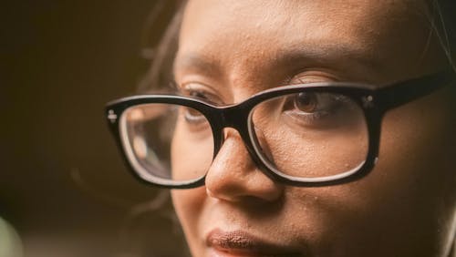Close-Up Photo of a Serious Person Wearing Eyeglasses