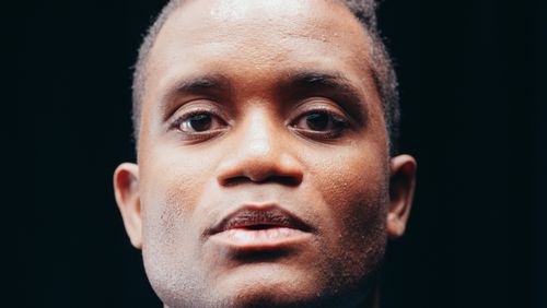 Free Close-up portrait of a man with a contemplative expression against a dark background. Stock Photo