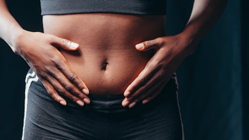 Free A Person Touching Her Belly Stock Photo