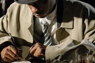 Close-Up Photo of Man Taking Down Notes