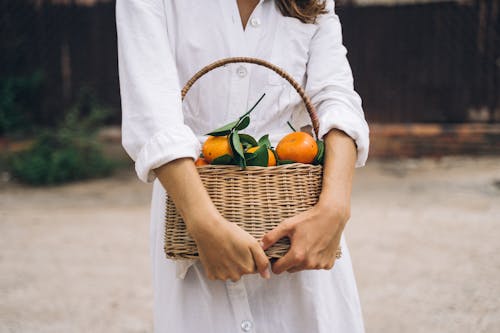 A Woman Holding a Woven Basket