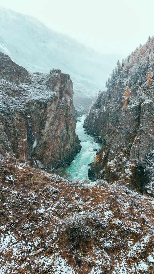 Free A breathtaking aerial view of a snowy canyon and river in Siberia during winter. Stock Photo