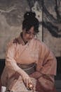 Beautiful Woman in a Pink Traditional Kimono Dress