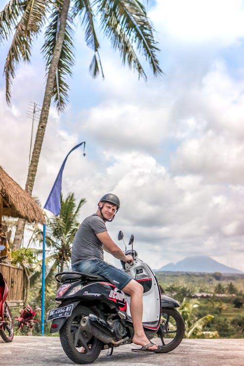 Free Man Riding Motor Scooter Stock Photo