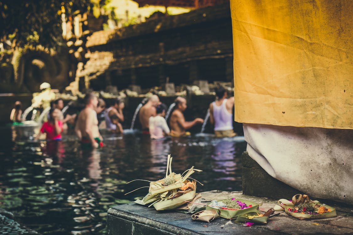 Photo of People in the Body of Water Taking a Bath