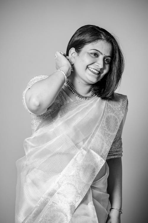 Free Grayscale Photo of a Smiling Woman Wearing Sari Stock Photo