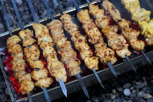 Free Delicious chicken kebabs grilling over hot coals, showcasing rich flavors and succulent textures. Stock Photo