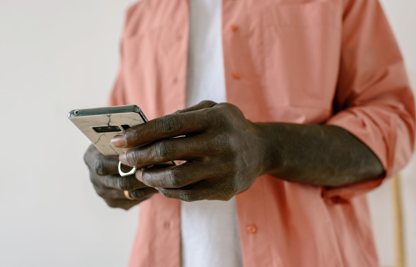 A close-up view of a person using a smartphone indoors, focusing on connectivity and technology.