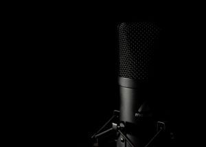 Condenser microphone in a darkened booth — photo by Nishant Ghosh on Pexels