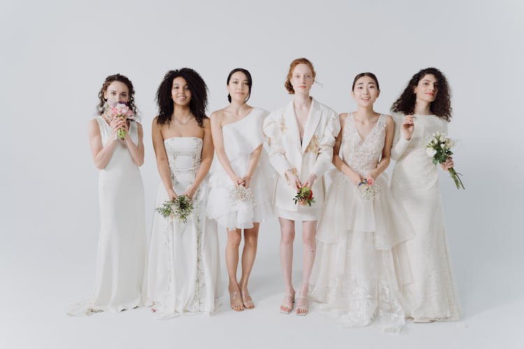 Brides In White Wedding Dresses Holding Wedding Bouquets