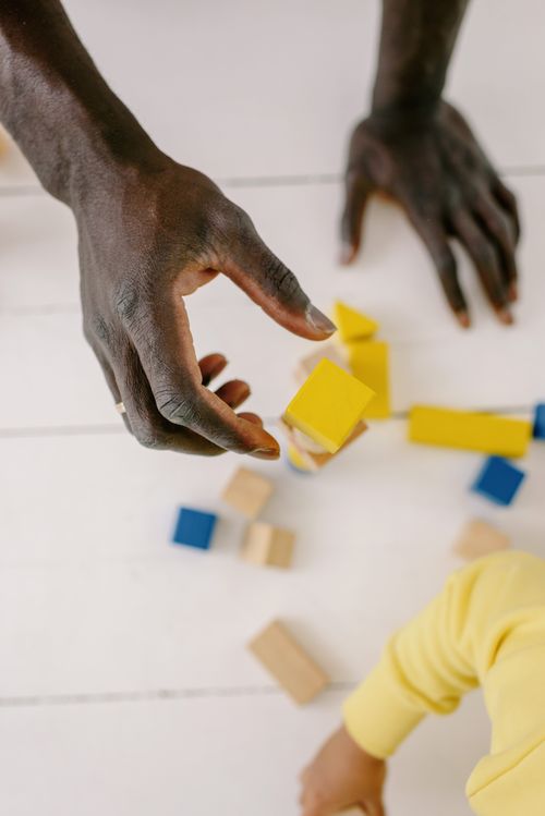 Free Engaging hands playing with colorful wooden blocks, perfect for creative play. Stock Photo