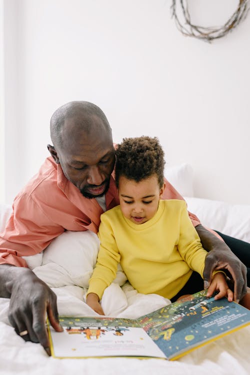 A Father and Son Reading a Book Together 