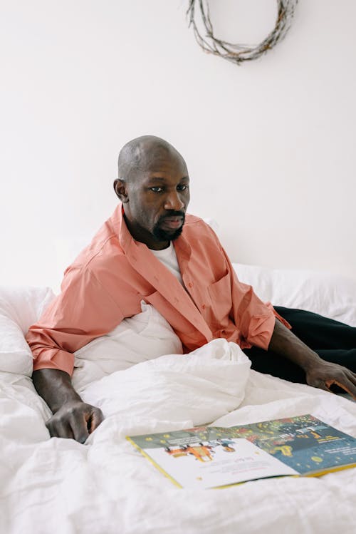 Man Sitting on the Bed