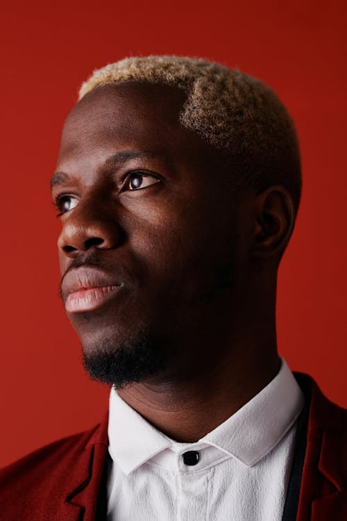 Close Up Shot of a Man with Red Back Ground