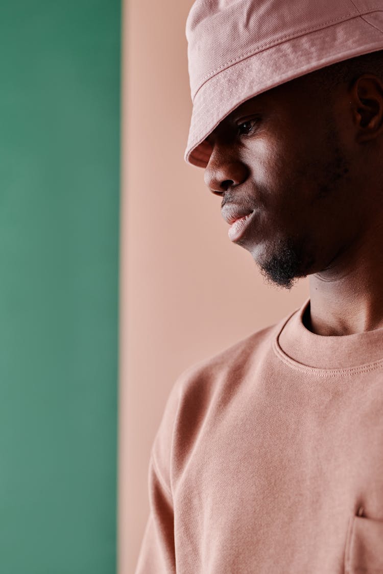 A Bearded Man In Pink Shirt And Bucket Hat