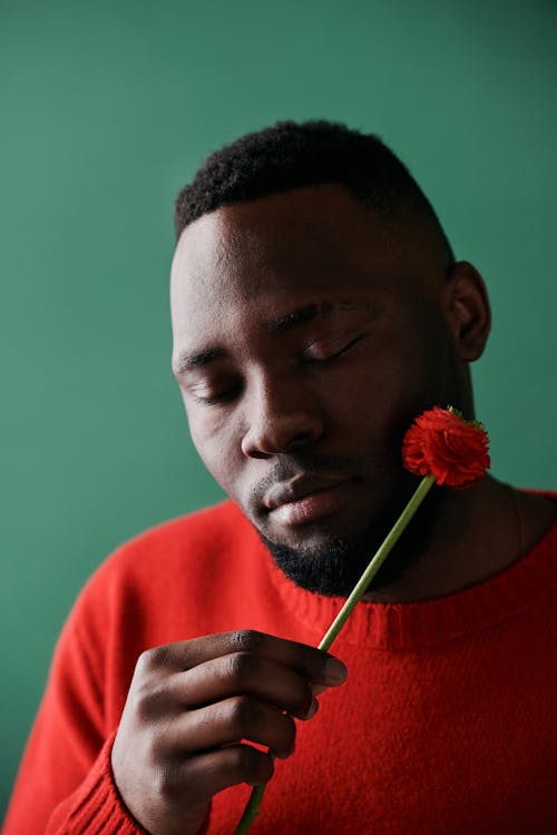 A Person Holding a Red Flower