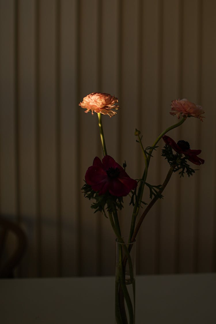 Carnation And Poppy Flowers In A Glass Vase