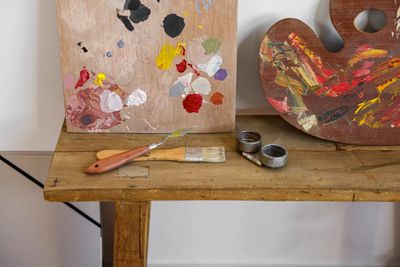 Loaded palettes resting against an easel — photo by Cup of Couple on Pexels