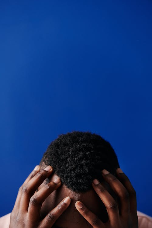 Free Man with His Hands on His Head in Close Up Photography Stock Photo