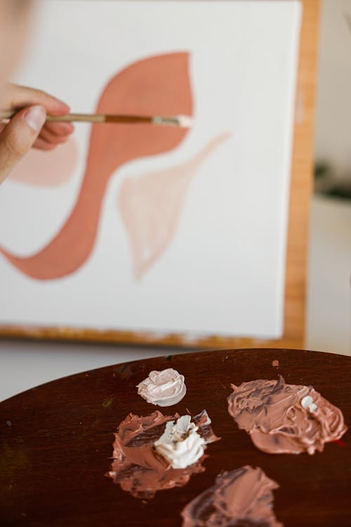 Close-up Photo of Paint Colors on a Wooden Artist Palette