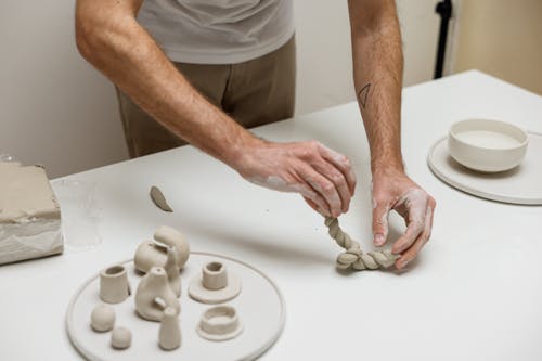 Man Crafting Objects from Clay