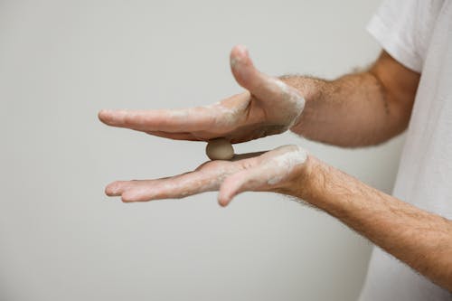 A Person in White Shirt Molding Clay 