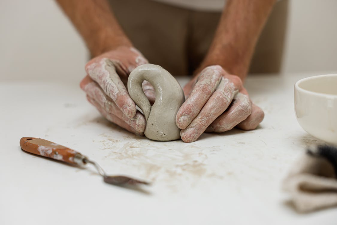 A Ceramist Shaping a Clay Dough