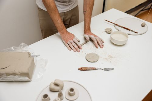 Free Close-up of artisan crafting ceramics by hand in a creative studio setting. Stock Photo