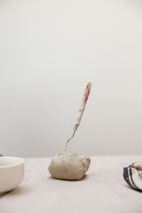 A Ball of Clay with a Spatula Stuck in It 
