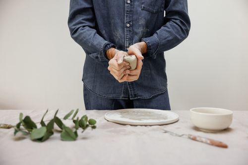 Free Close-up of hands shaping clay in a pottery studio, capturing the creative process. Stock Photo