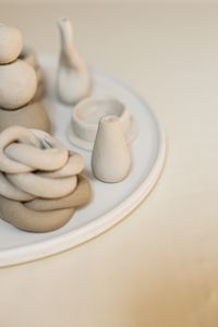Handcrafted ceramics on a beige background — photo by Cup of Couple on Pexels
