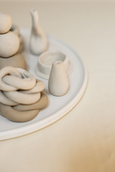 Hand-thrown ceramics on a beige ground — photo by Cup of Couple on Pexels